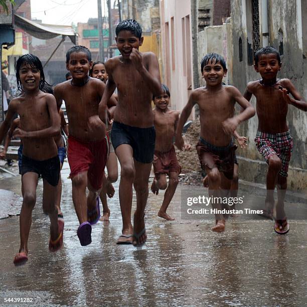 Dasna children enjoy pre-monsoon rain showers during the weekend, on July 3, 2016 in Ghaziabad, India. The maximum temperature was recorded at 30.2...