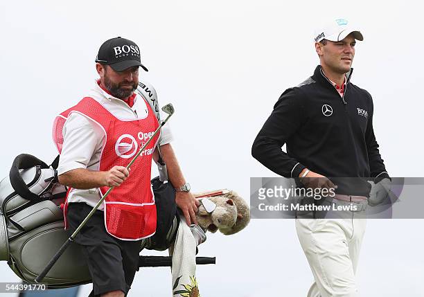 Martin Kaymer of Germany looks on with his caddie Craig Connelly during day four of the 100th Open de France at Le Golf National on July 3, 2016 in...