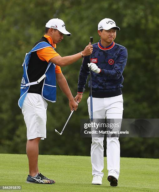 Jeunghun Wang of Korea looks on with his caddie during day four of the 100th Open de France at Le Golf National on July 3, 2016 in Paris, France.