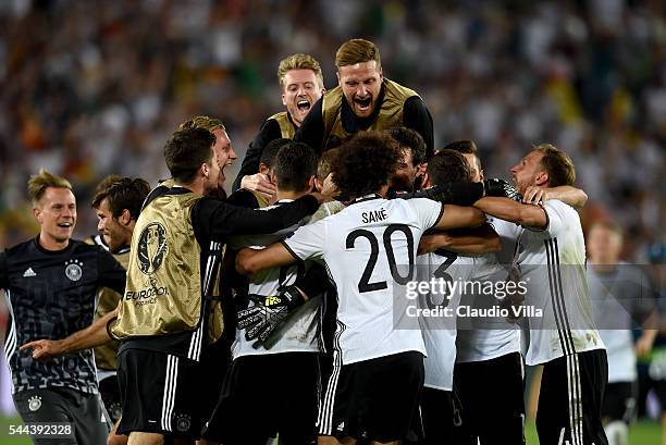 Germany players dash to celebrate their win through the penalty shootout after Jonas Hector scores to win the game after the UEFA EURO 2016 quarter...