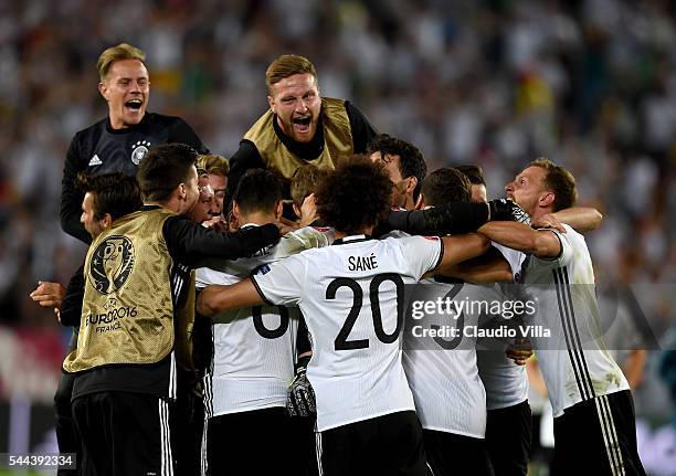 Germany players dash to celebrate their win through the penalty shootout after Jonas Hector scores to win the game after the UEFA EURO 2016 quarter...