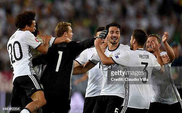 Germany players dash to celebrate their win through the penalty shootout after Jonas Hector scores to win the game after the UEFA EURO 2016 quarter...