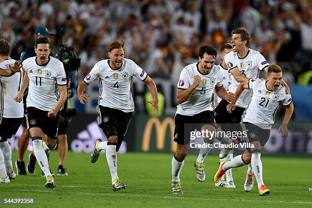 Germany players dash to celebrate their win through the penalty shootout after Jonas Hector scores to win the game after the UEFA EURO 2016 quarter...