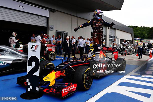 Max Verstappen of Netherlands and Red Bull Racing jumps off his car to celebrate his second place finish in parc ferme after the Formula One Grand...