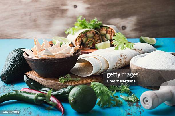 ingredients for mexican cooking. avocado, lime, hot chilli pepper,  and flour tortillas. authentic mexican meal concept - mexico chile fotografías e imágenes de stock