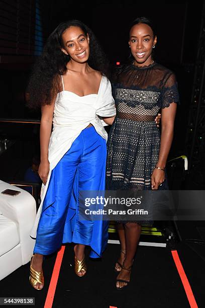 Singers Solange Knowles and Kelly Rowland pose for a photo backstage at the 2016 ESSENCE Festival Presented By Coca-Cola at Ernest N. Morial...