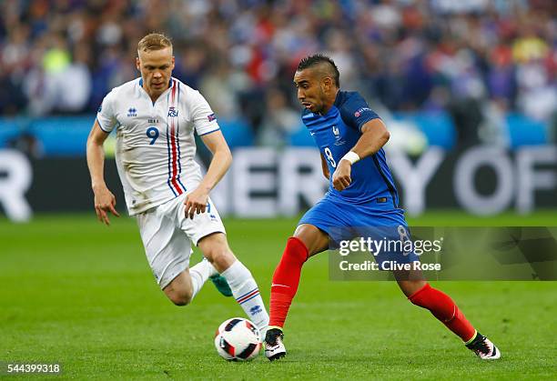 Dimitri Payet of France and Kolbeinn Sigthorsson of Iceland compete for the ball during the UEFA EURO 2016 quarter final match between France and...