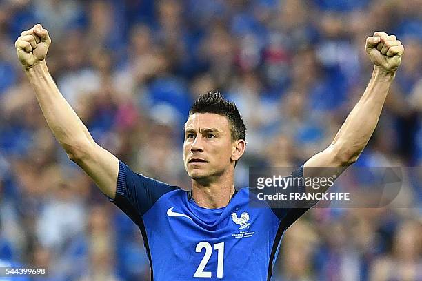 France's defender Laurent Koscielny celebrates France's first goal by a teammate during the Euro 2016 quarter-final football match between France and...
