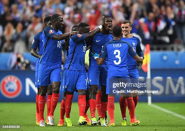 Paul Pogba of France celebrates scoring his team's second goal with his team mates during the UEFA EURO 2016 quarter final match between France and...