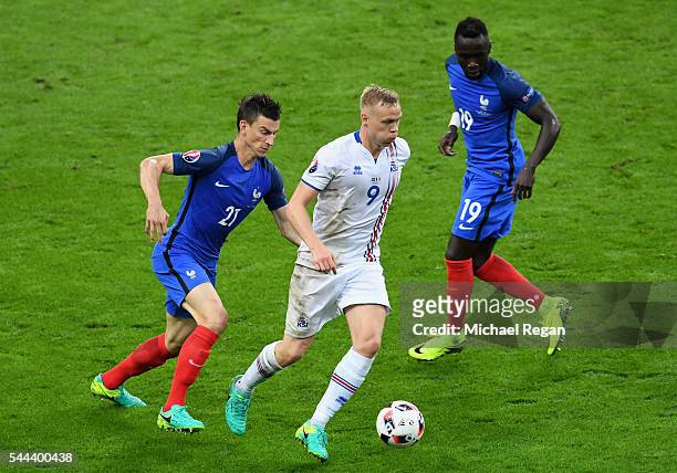 Kolbeinn Sigthorsson of Iceland and Laurent Koscielny of France compete for the ball during the UEFA EURO 2016 quarter final match between France and...