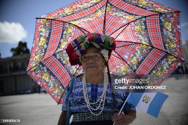 Woman attends a military parade during the celebration of the Army Day in Guatemala City, on July 3, 2016.