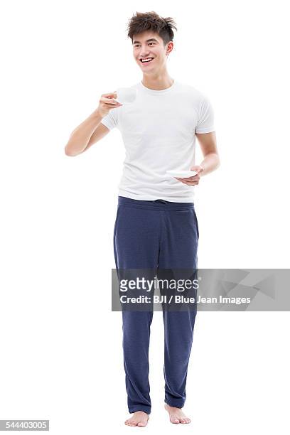 young man drinking coffee in the morning - fatigue full body stock pictures, royalty-free photos & images