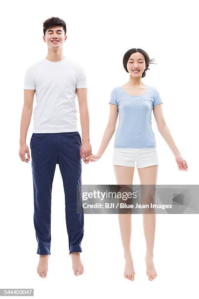 young couple sleeping in mid-air - asian man barefoot foto e immagini stock