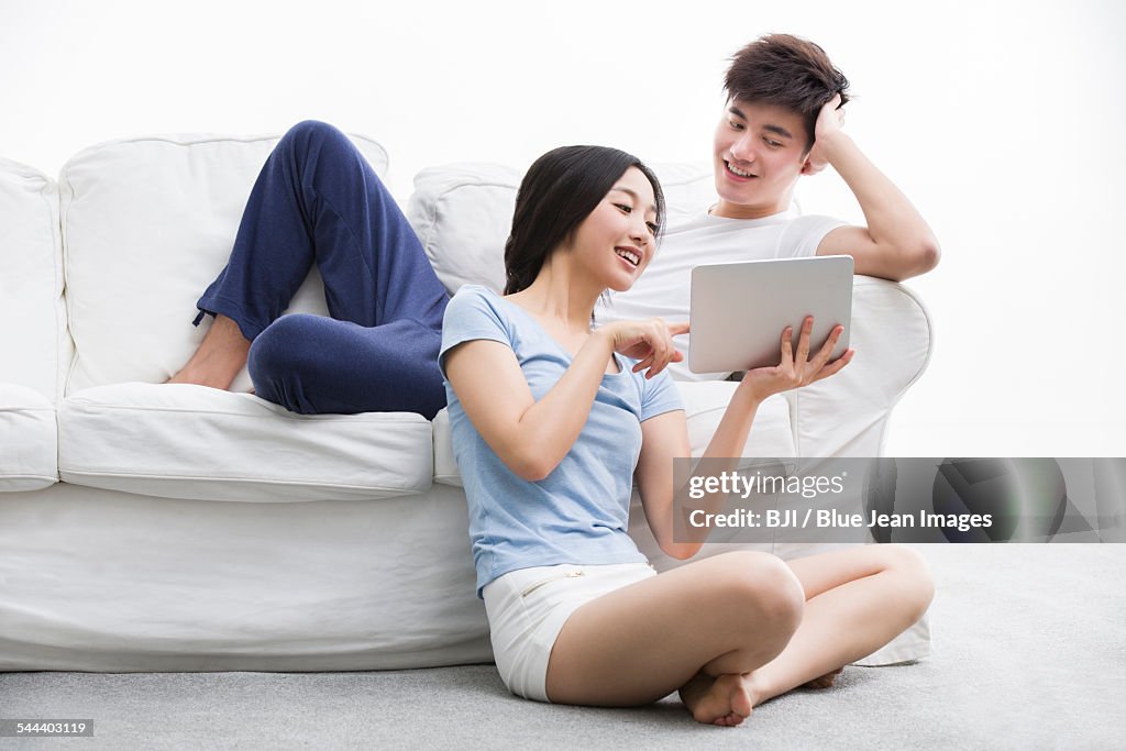 Young couple using digital tablet