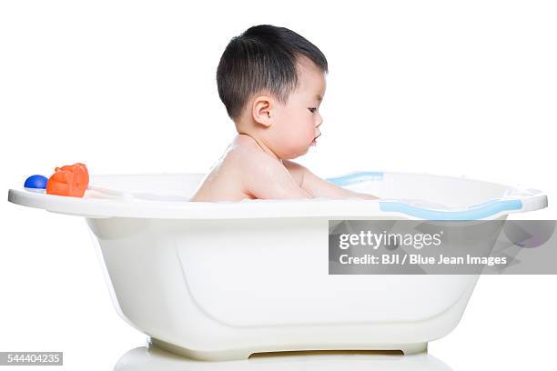 cute baby in bathtub - baby bath toys stock pictures, royalty-free photos & images