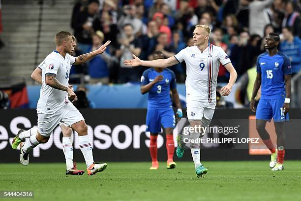 Iceland's forward Kolbeinn Sigthorsson celebrates after scoring a goal with Iceland's defender Ragnar Sigurdsson during the Euro 2016 quarter-final...