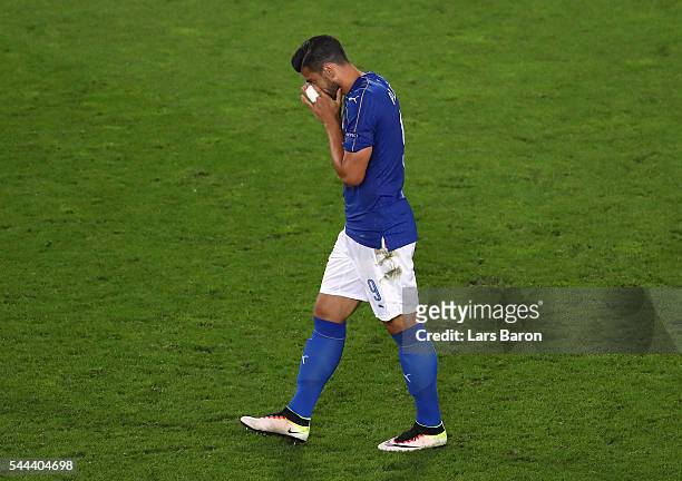 Graziano Pelle of Italy reacts after missing at the penalty shootout during the UEFA EURO 2016 quarter final match between Germany and Italy at Stade...