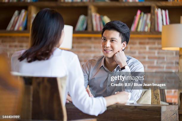 young woman and man talking in cafe - blind date stock pictures, royalty-free photos & images