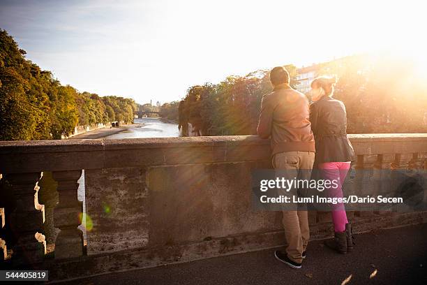 young couple standing on luitpoldbrcke, munich, bavaria, germany - tourism life in bavaria foto e immagini stock