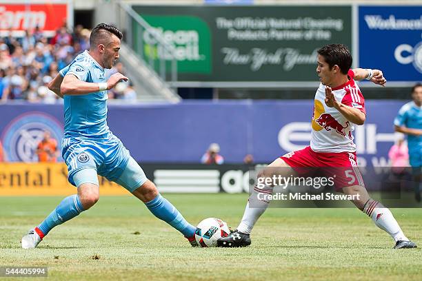 Midfielder Jack Harrison of New York City FC and defender Connor Lade of New York Red Bulls vie for the ball during the match at Yankee Stadium on...