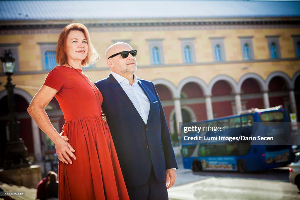 Senior couple stands on city street, Munich, Bavaria, Germany