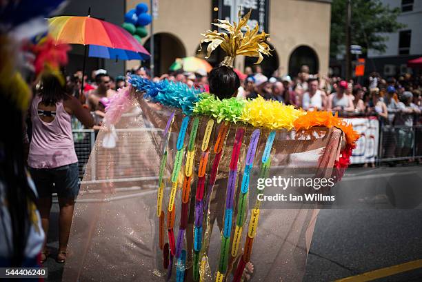 Parade participant carries a rainbow shawl, which displays the names of the Orlando shooting victims, at the annual Pride Festival parade, July 3,...