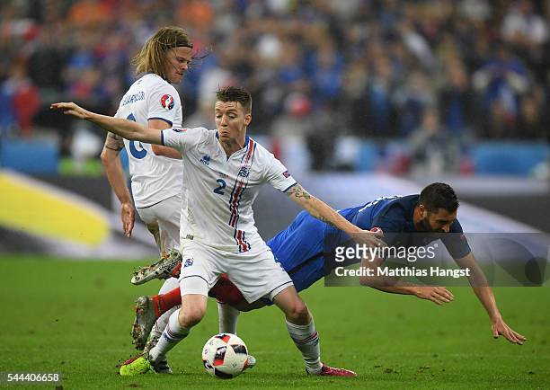Andre-Pierre Gignac of France competes for the ball agains Birkir Saevarsson and Birkir Bjarnason of Iceland during the UEFA EURO 2016 quarter final...
