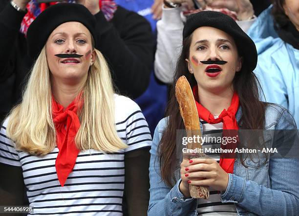 Female supporters dressed in French outfits holding a baguette before the UEFA Euro 2016 quarter final match between France and Iceland at Stade de...