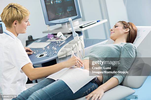 pregnant woman having an ultrasound - preventive care stock pictures, royalty-free photos & images