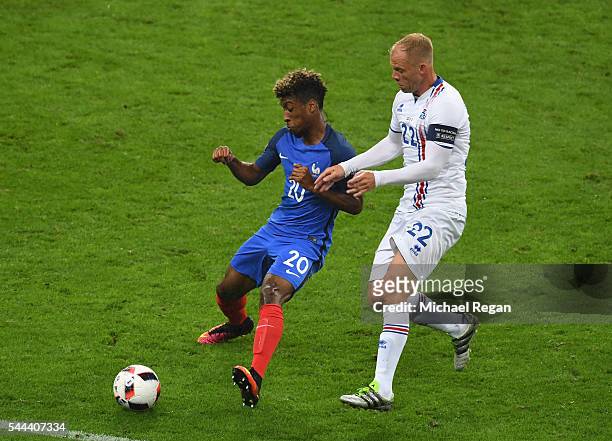 Kingsley Coman of France and Eidur Gudjohnsen of Iceland compete for the ball during the UEFA EURO 2016 quarter final match between France and...