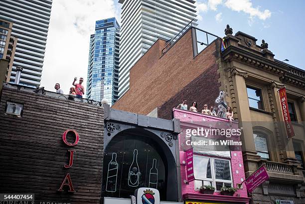 Parade spectators watch from Yonge Street rooftops, at the annual Pride Festival parade, July 3, 2016 in Toronto, Ontario, Canada. Prime Minister...