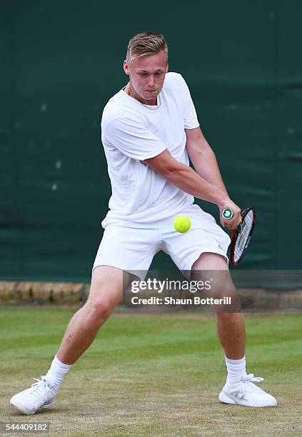 Finn Bass of Great britain plays a backhand during the Boy's singles first round match against Marvin Moeller of Germany on Middle Sunday of the...