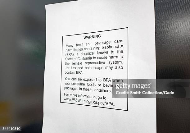 Warning regarding the presence of bisphenol A in beverage cans, part of California Proposition 65, is pasted to the side of a soda vending machine in...