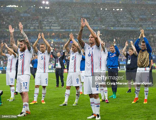 Iceland players applaud their fans at the end of the match during the UEFA Euro 2016 Quarter-final match between France and Iceland at on July 03 in...