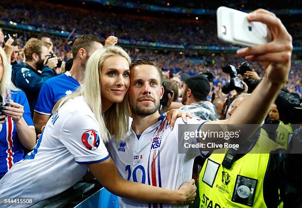 Gylfi Sigurdsson of Iceland takes a selfie photographs with his girlfriend Alexandra Ivarsdottir after the UEFA EURO 2016 quarter final match between...