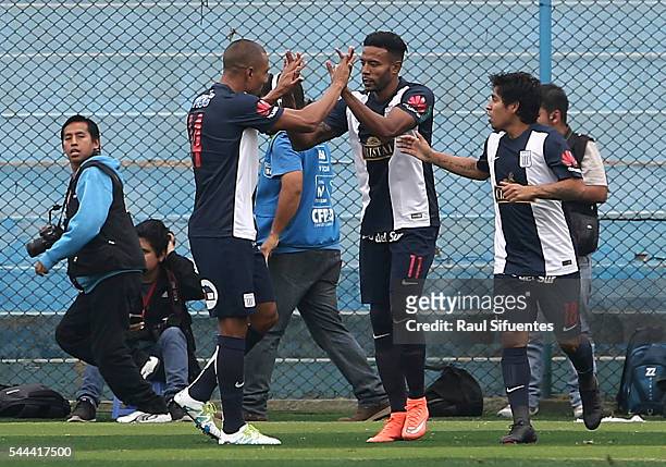 Lionard Pajoy of Alianza Lima celebrates with teammates after scoring the opening goal during a match between Sporting Cristal and Alianza Lima as...