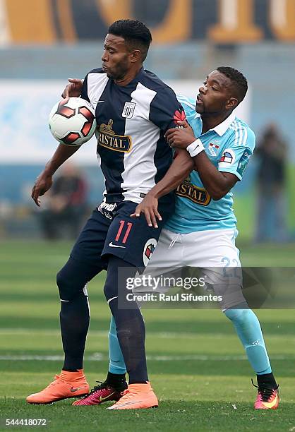 Jair Cespedes of Sporting Cristal struggles for the ball with Lionard Pajoy of Alianza Lima during a match between Sporting Cristal and Alianza Lima...