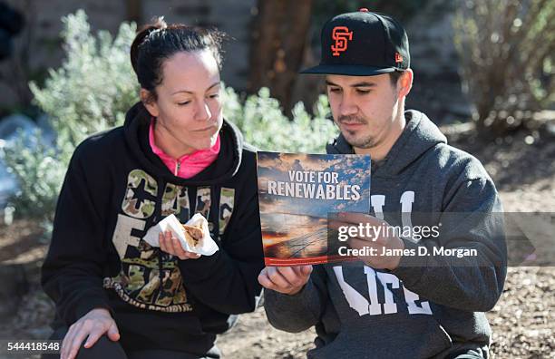 Young couple with their sausage sizzle consider their vote before entering the election booth on July 2, 2016 in Sydney, Australia. Sausage sizzles...