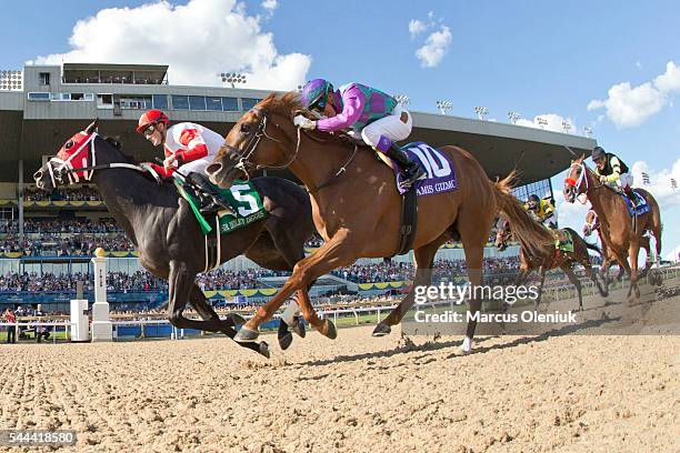 Jockey Julien Leparoux, riding Sir Dudley Digges, crosses the finish line of the 157th running of the Queen's Plate horse race in first place edging...