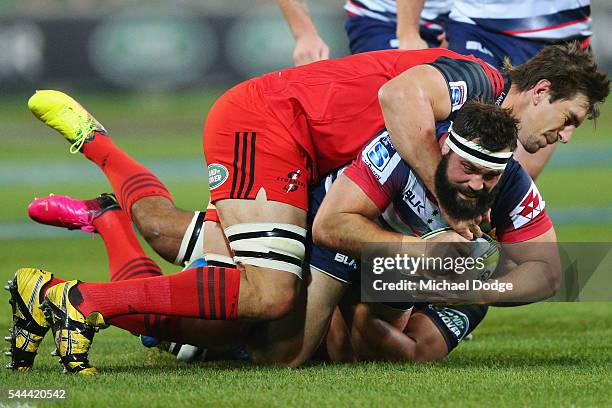 James Hanson of the Rebels is tackled by Eben Etzebeth of the Stormers during the round 15 Super Rugby match between the Rebels and the Stormers at...