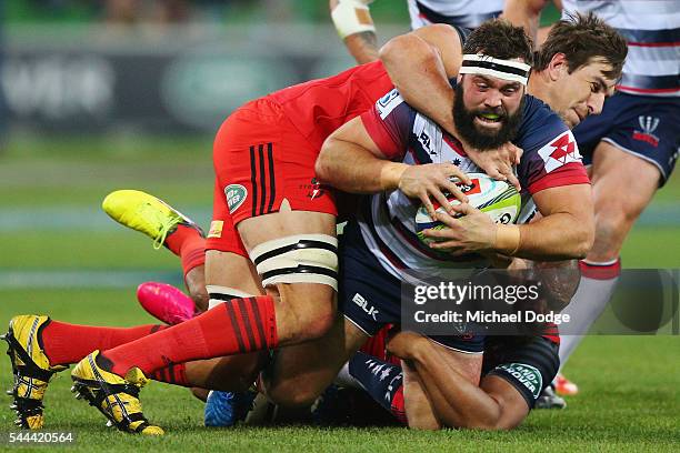 James Hanson of the Rebels is tackled by Eben Etzebeth of the Stormers during the round 15 Super Rugby match between the Rebels and the Stormers at...