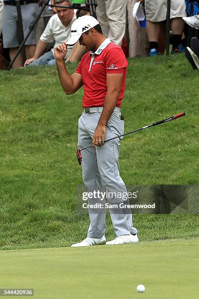 Jason Day of Australia reacts after a shot on the 17th hole during the final round of the World Golf Championships - Bridgestone Invitational at...