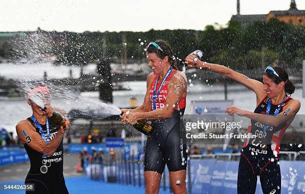 Flora Duffy of Bermuda celebrates with Andrea Hewitt of New Zealand and Helen Jenkins of Great Britian after winning the ladies ITU World Triathlon...