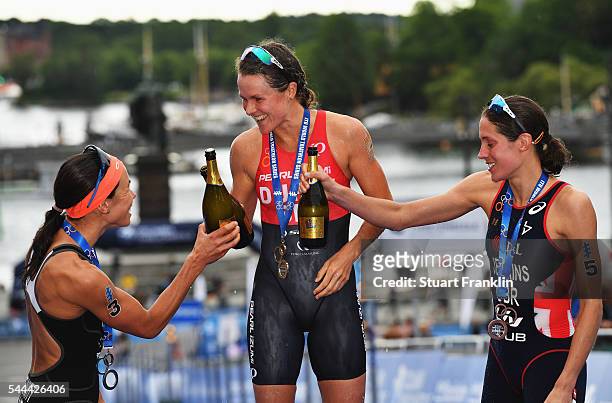 Flora Duffy of Bermuda celebrates with Andrea Hewitt of New Zealand and Helen Jenkins of Great Britian after winning the ladies ITU World Triathlon...