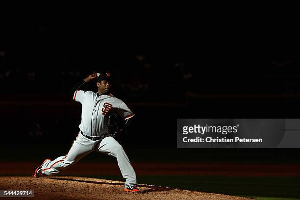 Relief pitcher Santiago Casilla of the San Francisco Giants pitches against the Arizona Diamondbacks during the 11th inning of the MLB game at Chase...