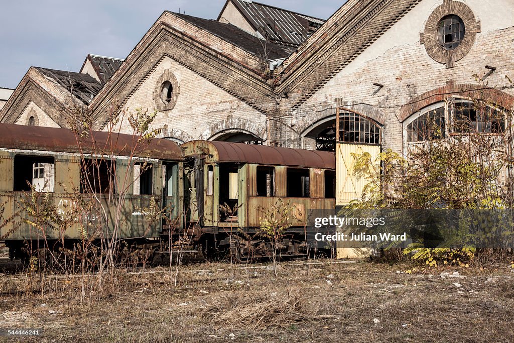 Abandoned train carriages and railway shed, Inota, Hungary
