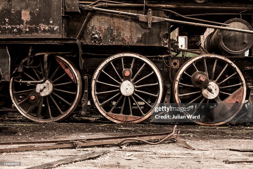 Detail of steam train wheels in railway shed, Inota, Hungary
