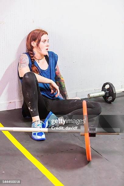 exhausted cross training athlete rests after a weightlifting workout - circuit training stock pictures, royalty-free photos & images