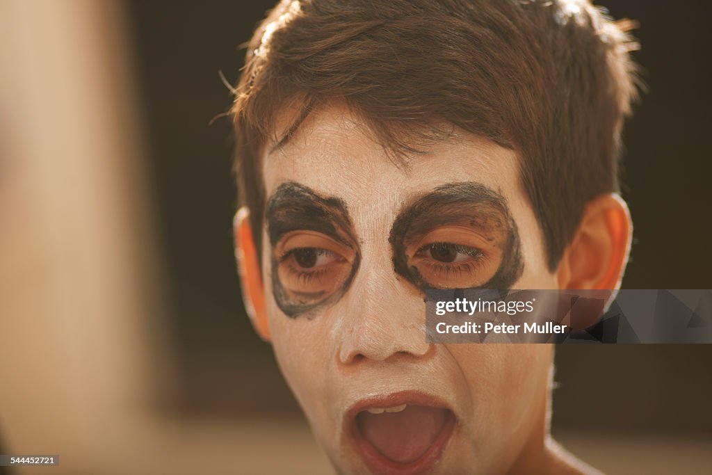 Close up of boy with skeleton face paint for halloween