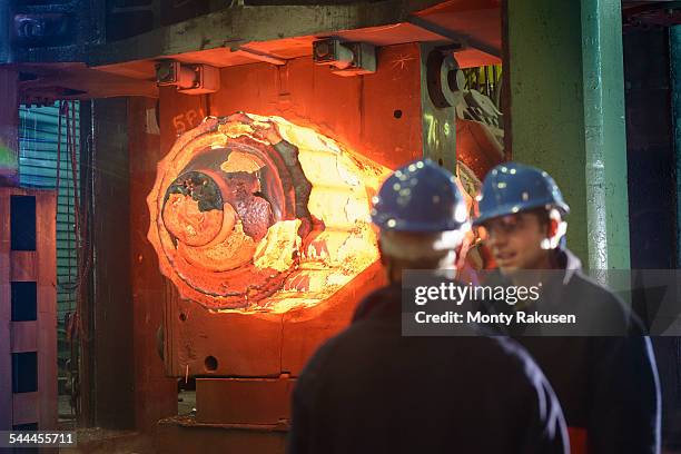 steelworkers with 10,000 tonne forging press in steelworks - iron forge stock pictures, royalty-free photos & images